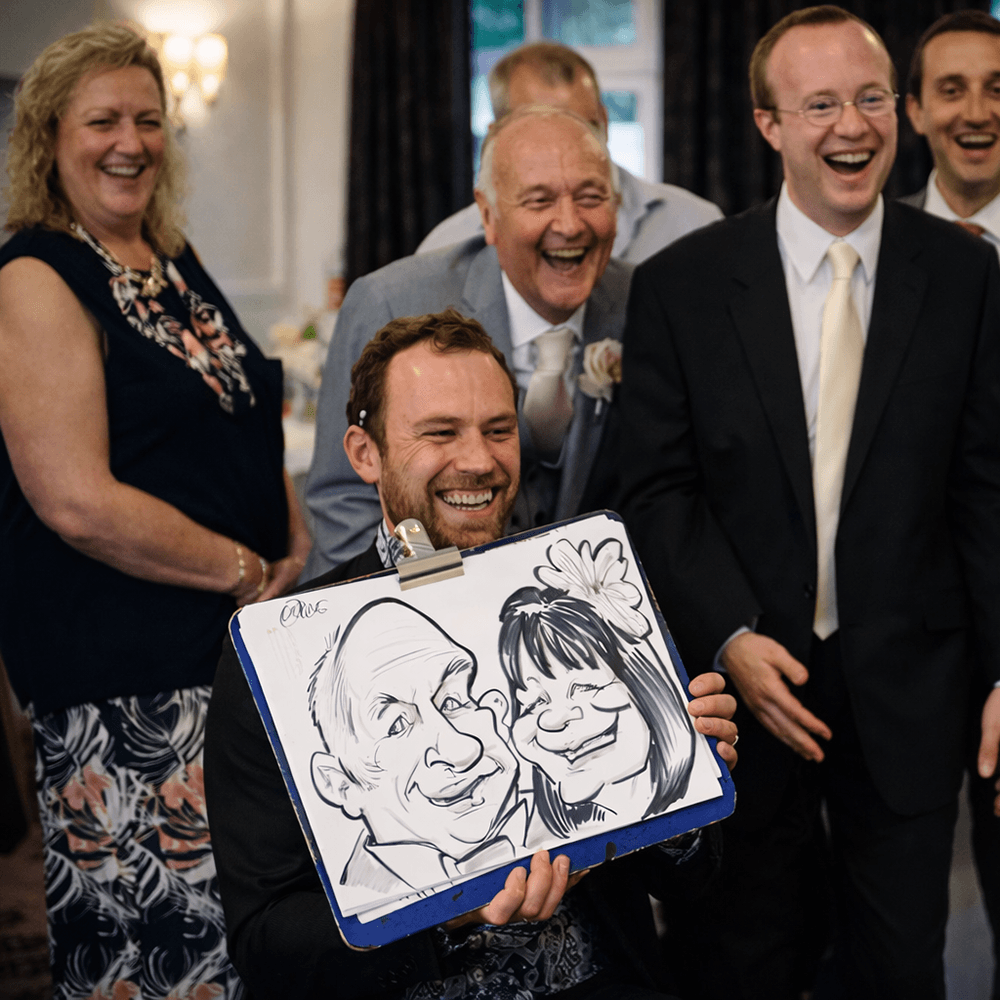 Wedding caricature artist revealing a caricatures South West Wedding