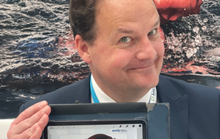 Booth-activation-for-conference-Europe-S Live digital caricature artist drawing branded guest portraits at a busy corporate trade show stand