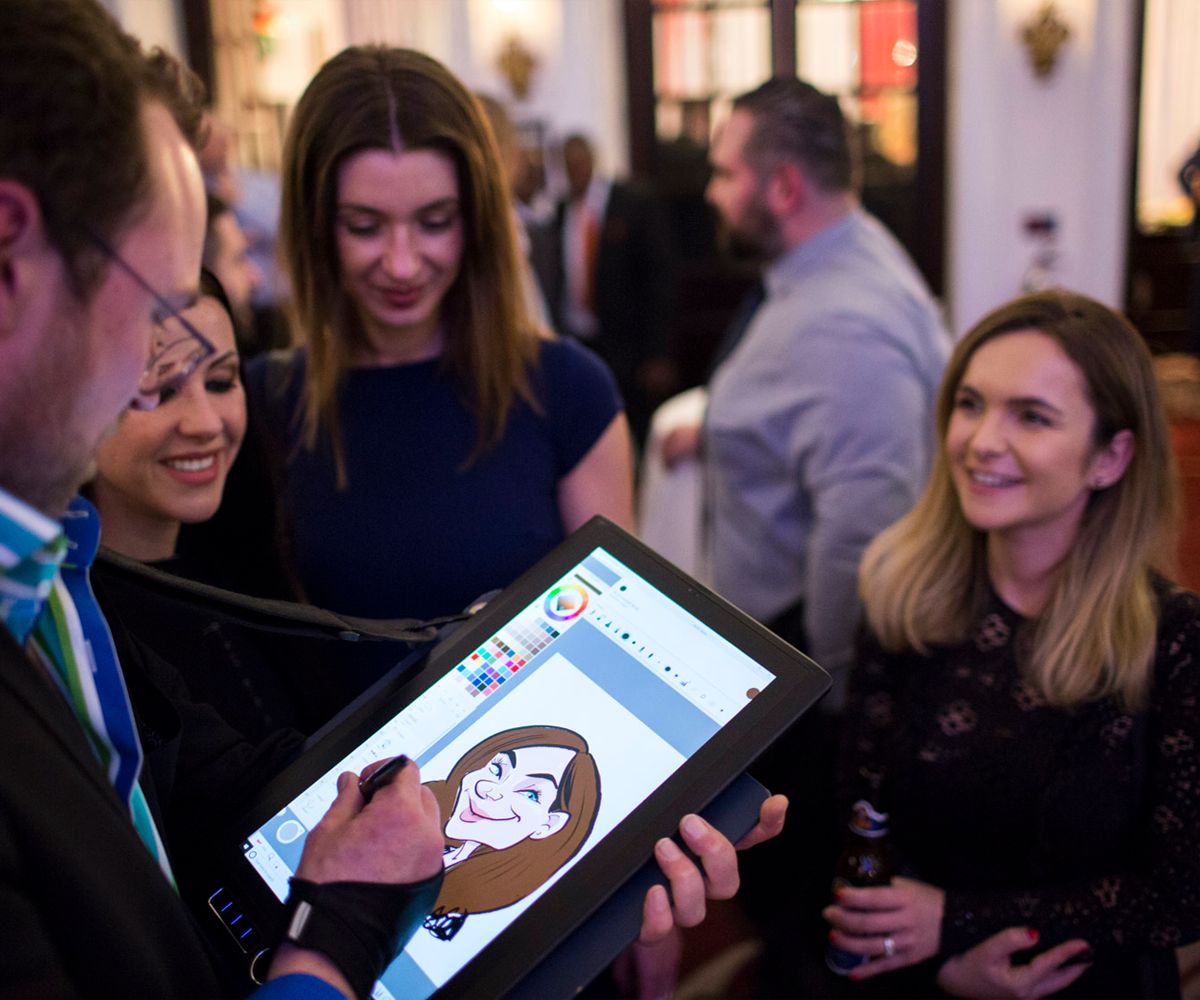 Digital-caricatures-for-awards-evening-entertainment Digital caricature entertainment at corporate event with guests watching live drawing