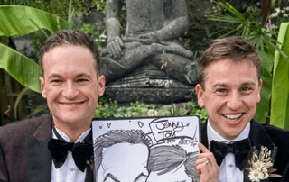 LGBTQ+ guys holding wedding caricature with buddha