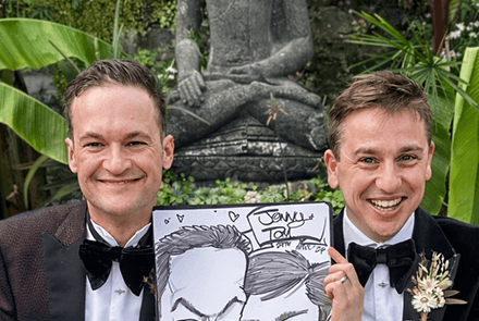 Two-lgbtq-guys-holding-wedding-caricature-S LGBTQ+ guys holding wedding caricature with buddha