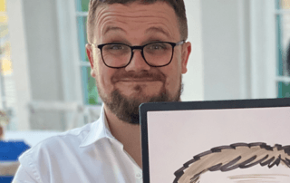 Wedding best man holding their caricature