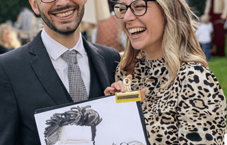 wedding-caricature-couple-smiling-S Wedding guests holding their caricature and laughing