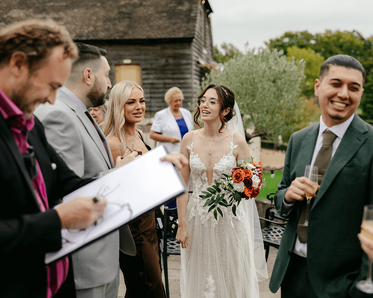 Wedding guests watching a caricature artist during a drinks reception