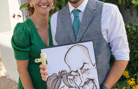 Couple holding a fun Caricature drawn live at a wedding South West England