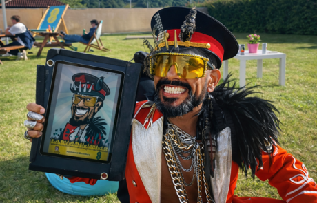 Outrageous guy in fancy dress with digital caricature drawn backstage at Glastonbury Festival