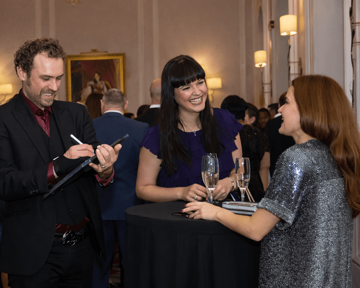 Caricature artist drawing corporate guests