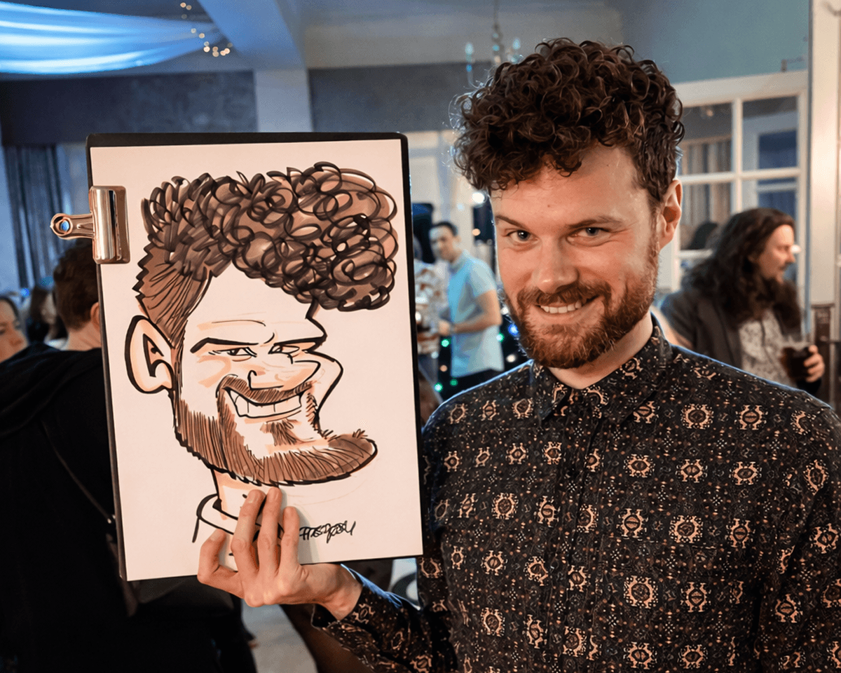 Party caricature artist drawing a guest at a private celebration with live caricatures