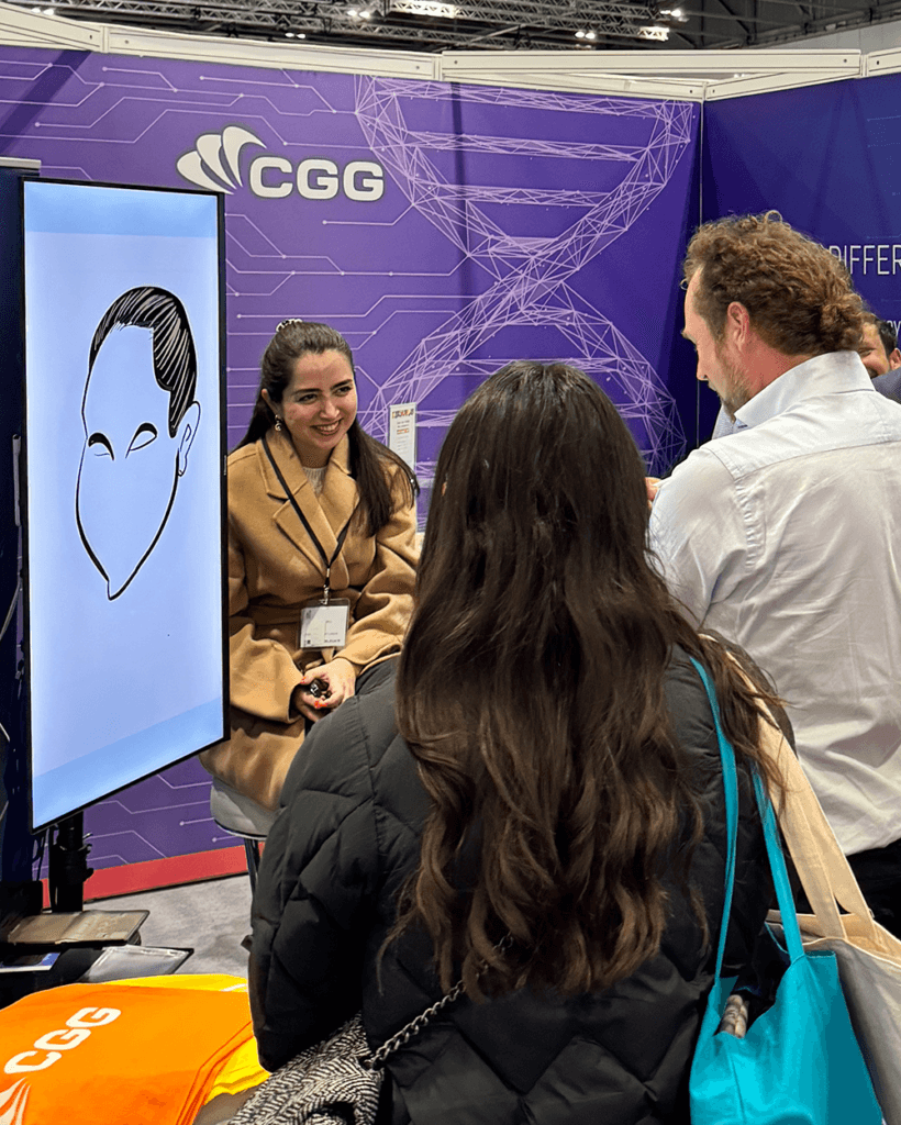 Artist drawing on iPad with a big screen display