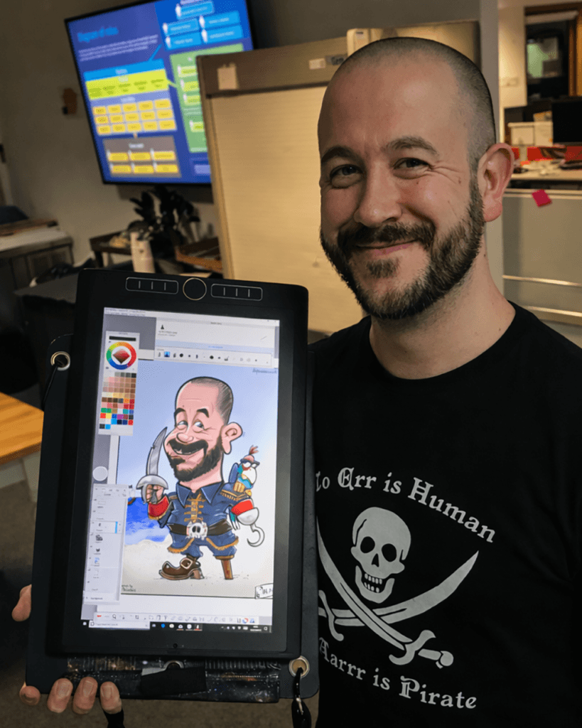 Party guest dressed as a pirate with his caricature