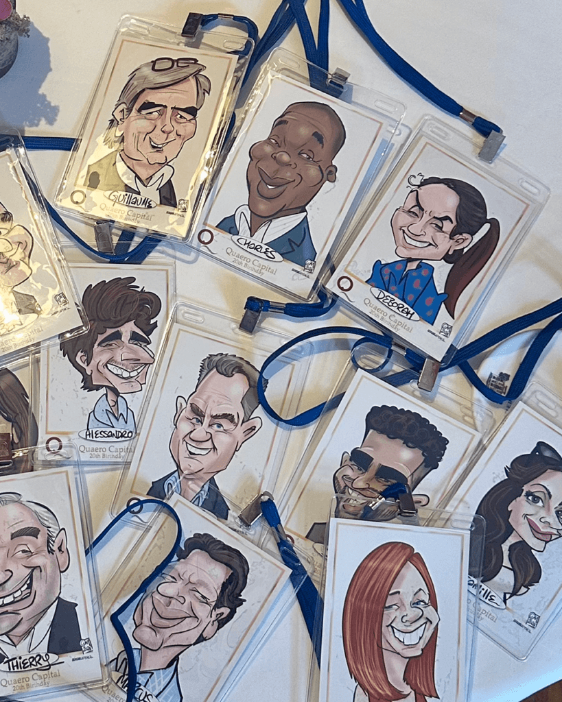 Caricatures printed out in protective sleeves and lanyards