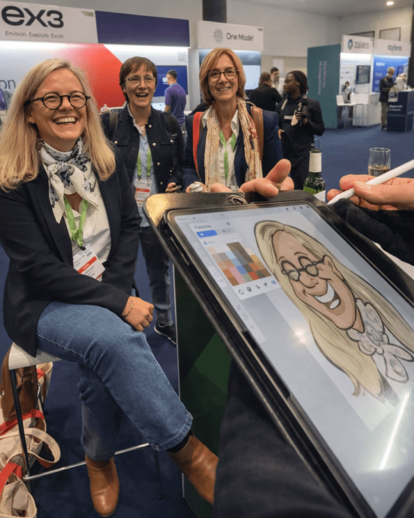 Ladies at trade event being drawn on an iPad