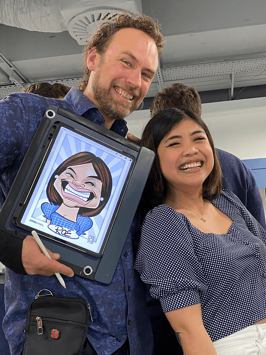 iPad-caricaturist-with-happy-guest-and-caricature Digital Caricaturist Christian Marshall with happy guest and her portrait