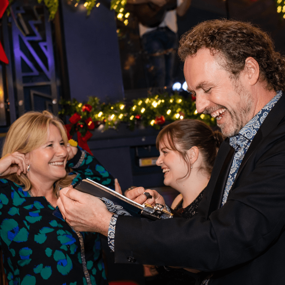 caricature artist drawing pen and paper caricatures at a xmas party