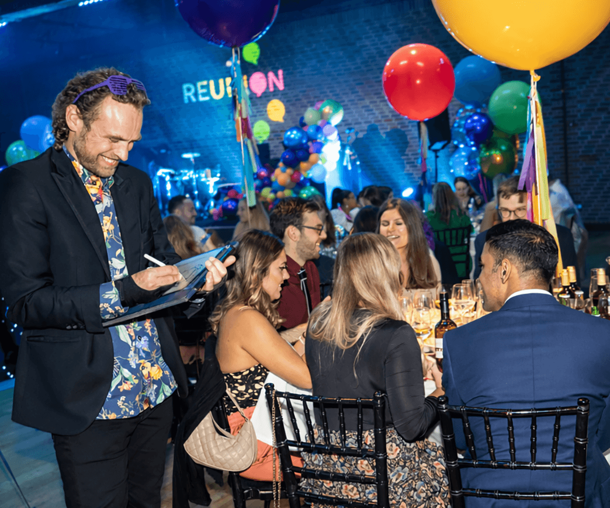 corporate party caricature artist drawing guests around the tables