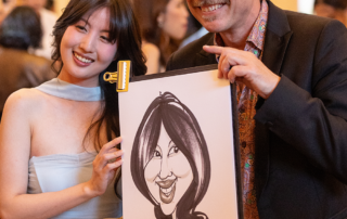 Caricature artist with guest at graduation event