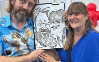 Colleagues with their black and white caricature at a corporate reception