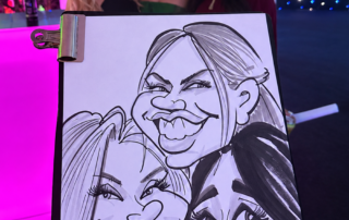 Group of young women at corporate event with their caricature