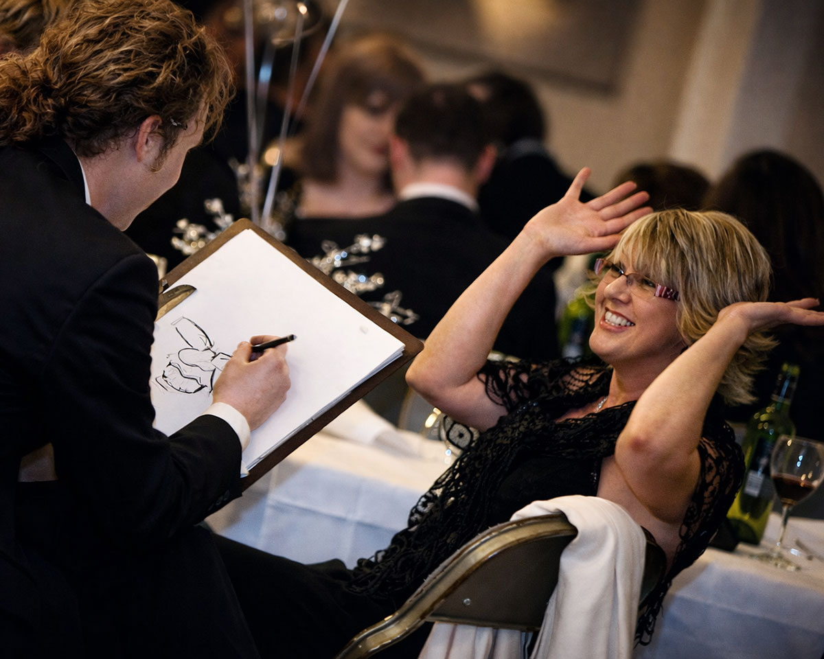 Dinner dance guest and caricaturist at glamorous event