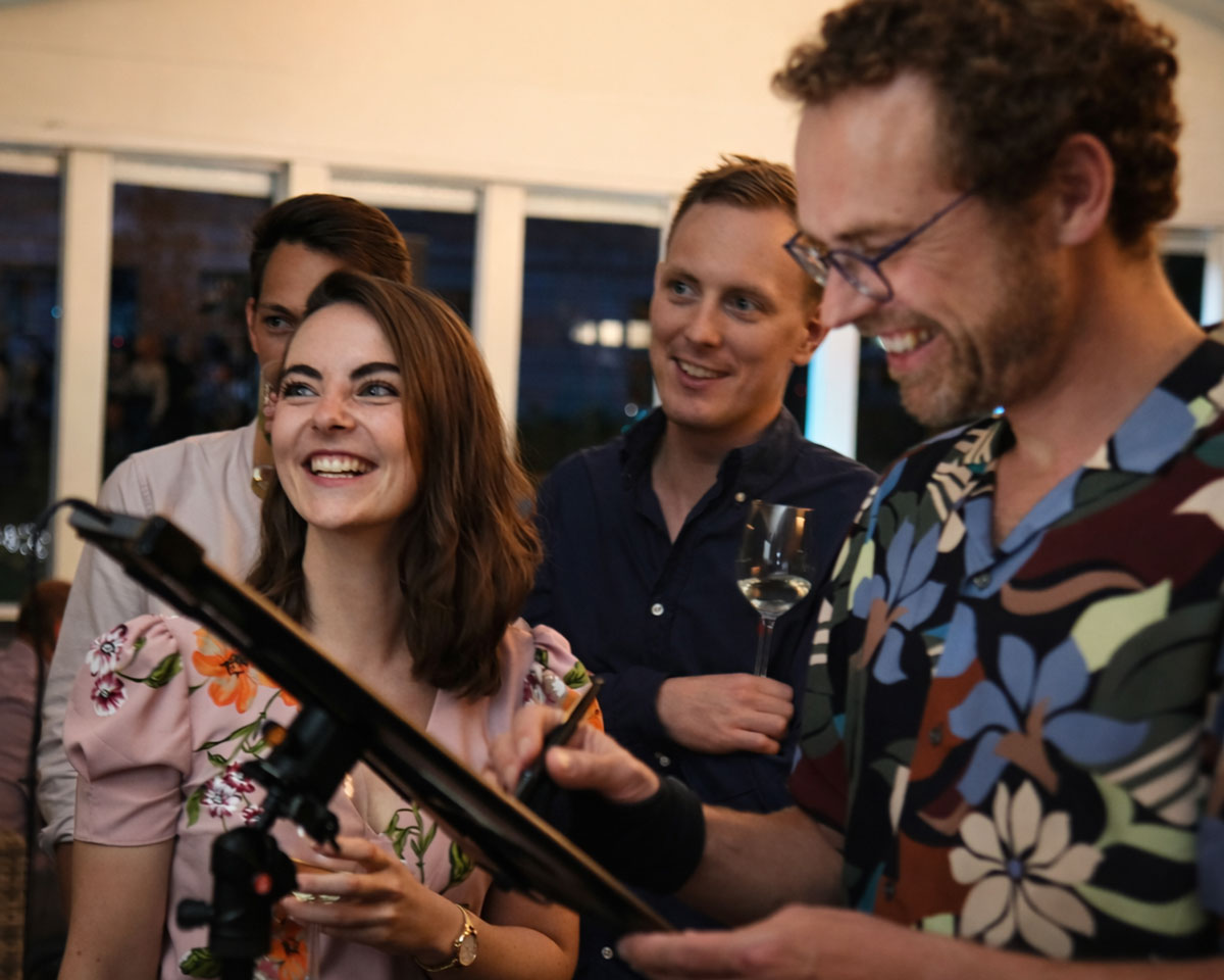 Guests gathered around to e=watch live digital caricature