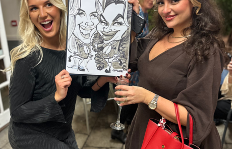 Guests holding their party caricature drawn in minutes