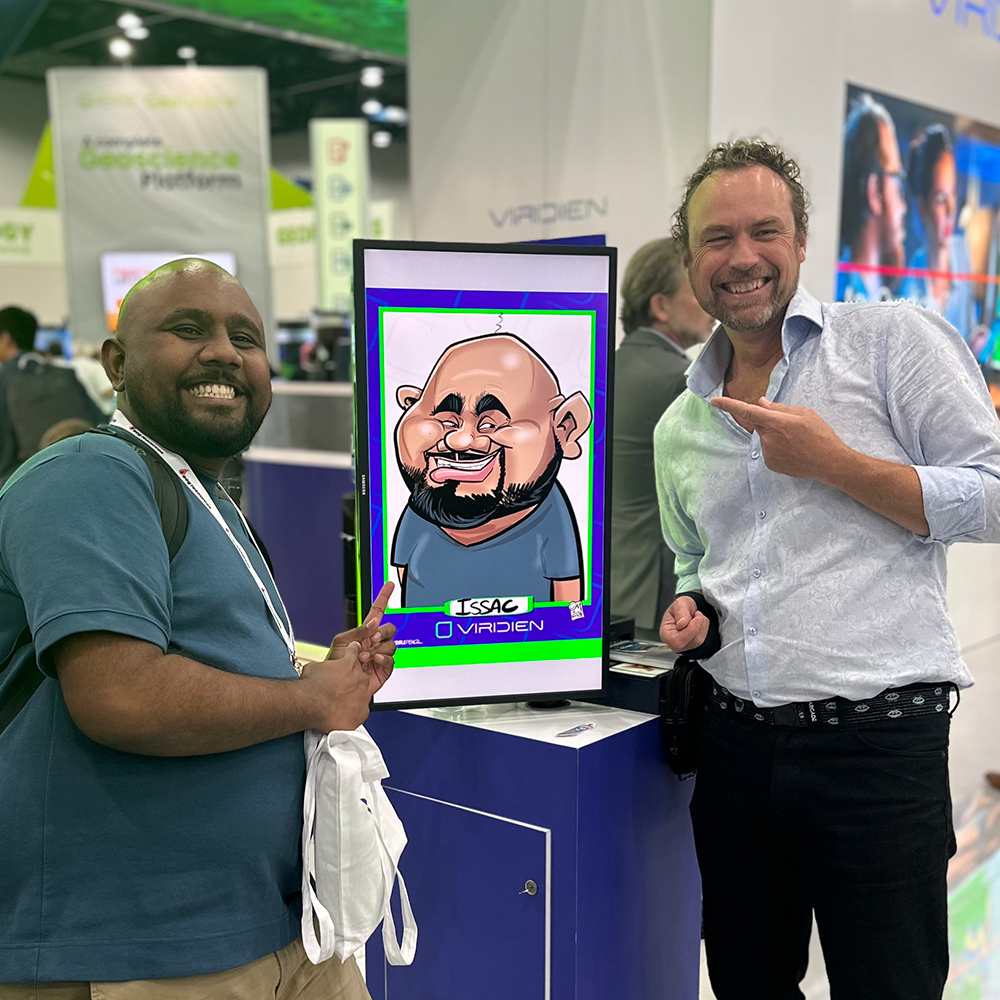 Viridien-caricature-booth-Houston Caricaturist and guest with digital caricature at tech event