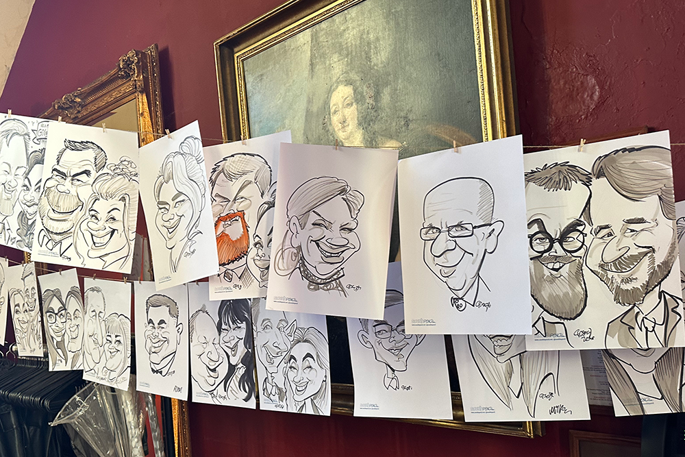 hanging gallery of caricatures at a wedding