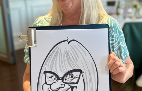 Mother of the bride holding wedding caricature